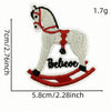 A light gray cartoon horse iron-on patch with a red bridle and the word Believe on a red saddle.