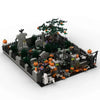 A detailed miniature diorama of a haunted house featuring trees, spooky structures, and Halloween decorations.