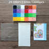 A collection of 24 colors of 2.6mm fuse beads in a plastic tray and a sheet of white material.