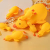A collection of bright yellow squishy duck fidget toys arranged on a light background.