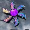 A rainbow metal fidget spinner featuring iridescent purple and blue blades surrounding a smooth, reflective sphere.