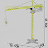 A yellow diecast construction crane model toy set with a long vertical mast and a horizontal jib.