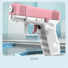 A pink and white high-pressure water blaster toy gun is shown resting on a tiled surface.