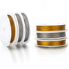 Rolls of stainless steel beading wire in gold and silver colors displayed on a white surface.