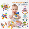 A baby is holding and interacting with a colorful silicone pull-string sensory toy for development.