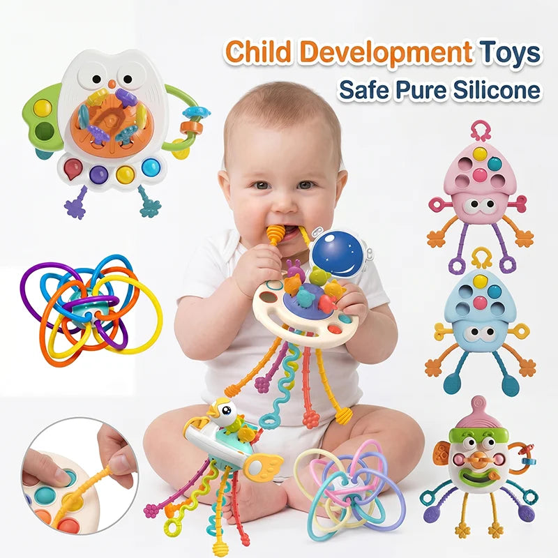 A baby is holding and interacting with a colorful silicone pull-string sensory toy for development.