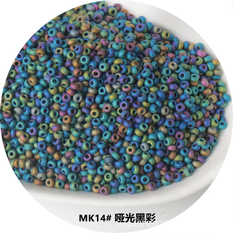 A pile of small, iridescent metallic glass beads in various shades of blue and green.