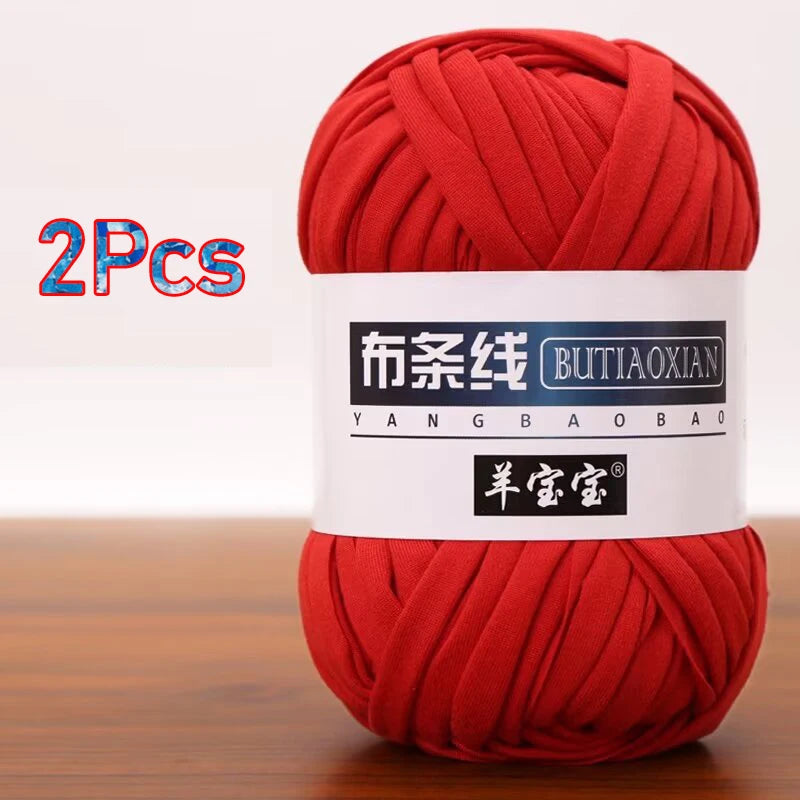 Two skeins of red yarn labeled as Yangbao Bao for crochet and knitting projects