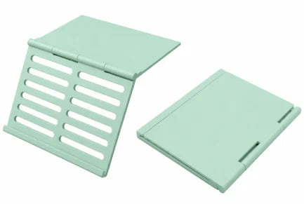 A light mint green foldable Mahjong card holder with a non-slip stand.