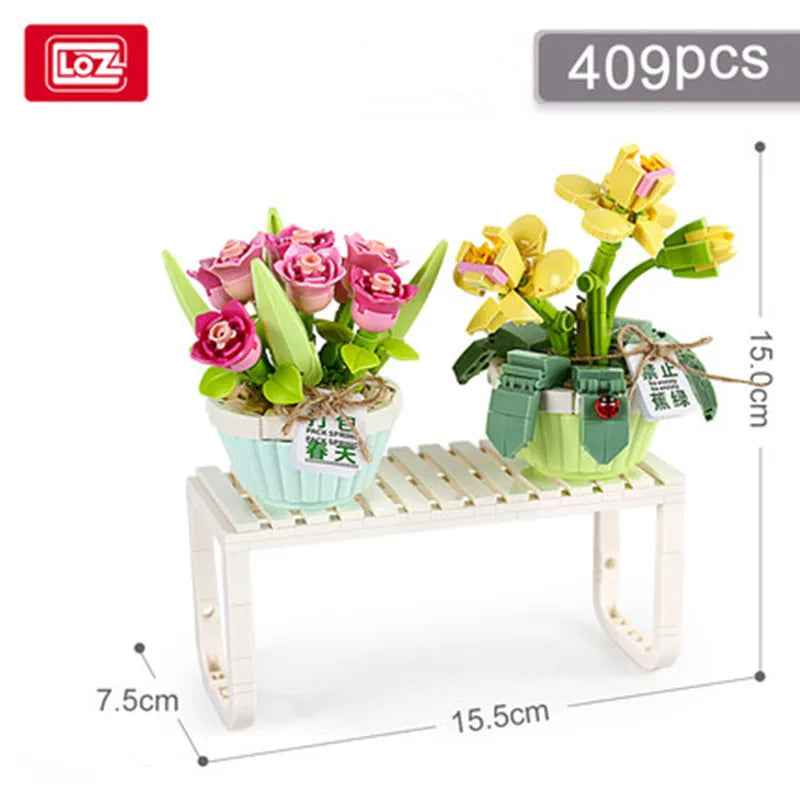 A set of 409 floral building blocks featuring pink and yellow flowers displayed on a wooden shelf.