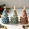 Three silicone candle molds shaped like Christmas trees with star and snowflake details