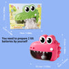 A pink frog water wheel bath toy with large eyes and a mouth, shown next to its packaging.