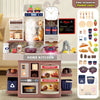 A pink kids pretend kitchen play set with various cooking accessories and a microwave oven.