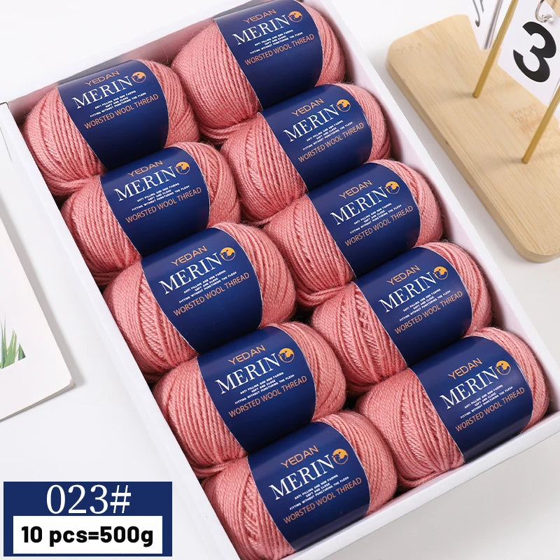 A box of 10 skeins of YEDAN MERIN worsted wool thread yarn in pink and blue colors for knitting projects