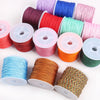 A collection of colorful 0.8mm cotton nylon macrame cord rolls in various shades and colors for jewelry making and crafts.