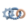 A set of food-grade silicone planet teethers for babies, featuring a light blue star shape and a wooden ring.
