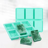 A teal silicone soap mold set with six cavities featuring intricate lace patterns for handmade soaps and crafts.