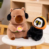 A brown capybara plush toy is sitting and holding a pink lotus flower next to a black and white panda plush toy.