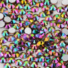 A close-up view of various iridescent and colorful glass crystal flatback rhinestones for nail art and crafts.
