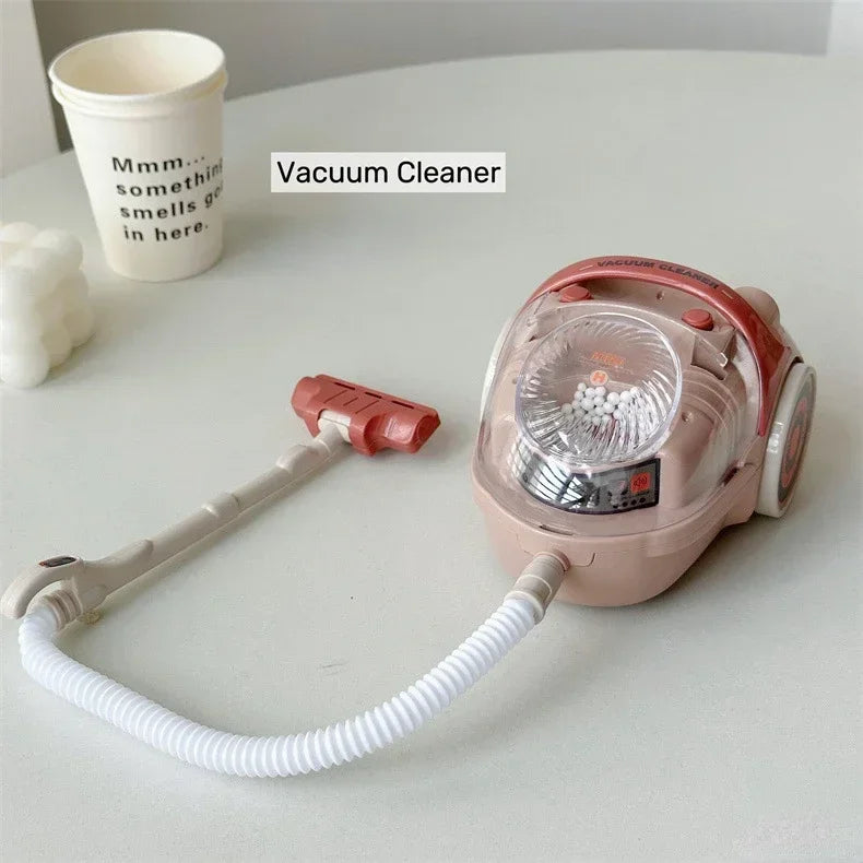 A pink vacuum cleaner with a hose and cleaning head is shown next to a white cup.