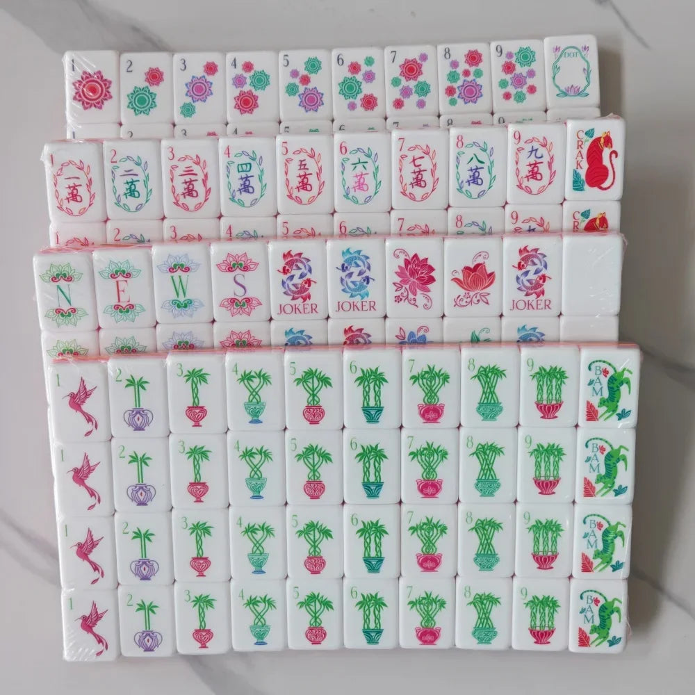 A stack of four layers of pearl pink acrylic American Mahjong tiles featuring various colored and patterned tiles.