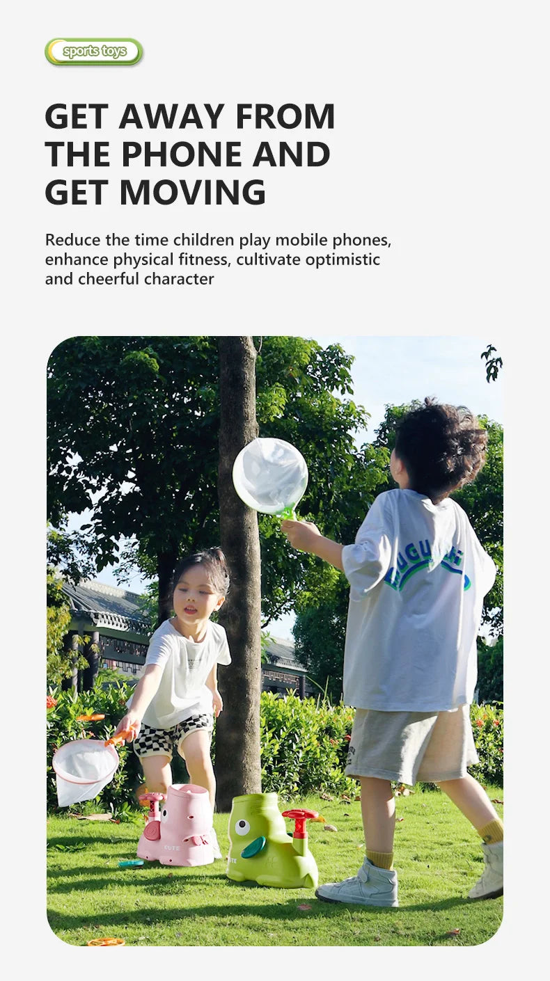 A young child is playing with a green foot launcher toy and a white flying disc in a grassy outdoor setting.