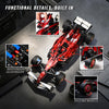 A red open-wheel racing car model kit showing functional details like opening body panels, independent suspension, and rollin