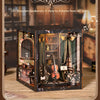 A wooden music box display featuring various musical instruments and decorative items, set within a dark wooden box.