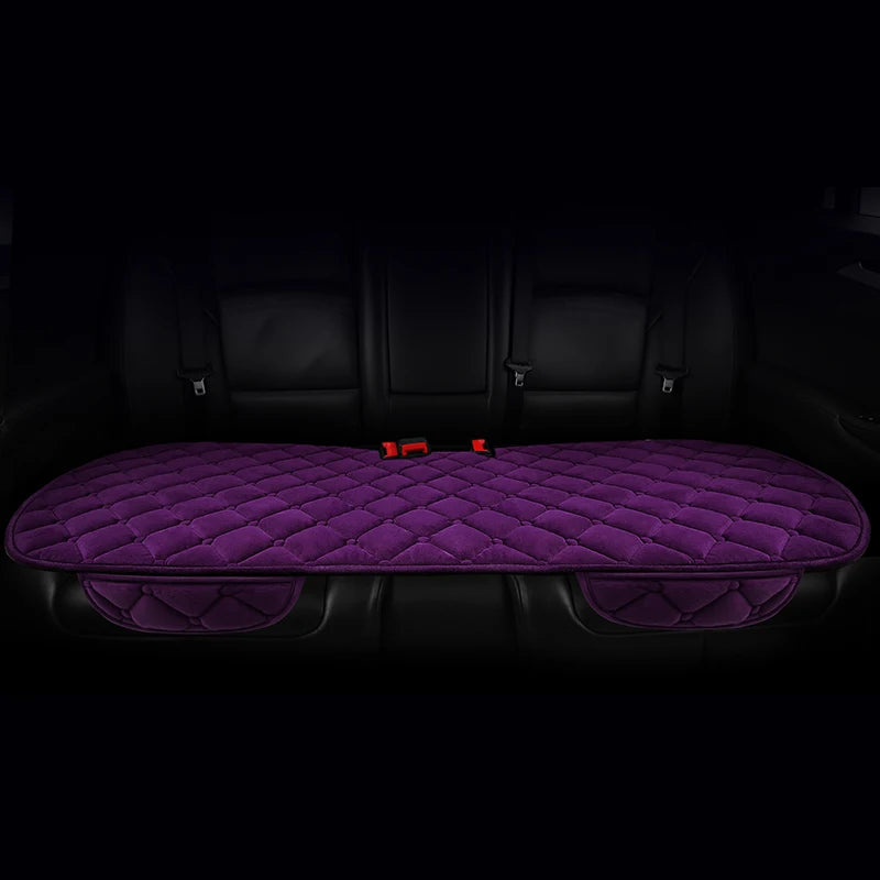 A purple quilted car seat cushion set with black leather upholstery shown in a vehicle interior.