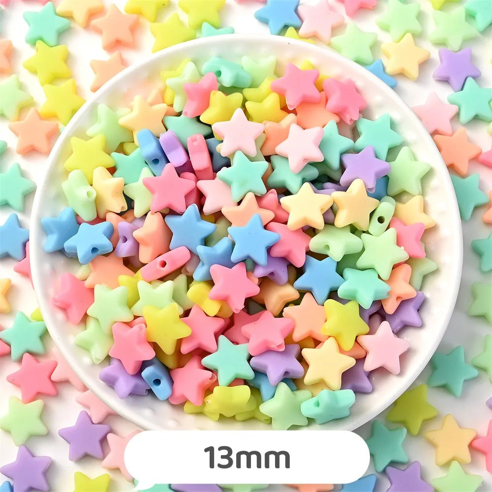 A bowl filled with pastel bear-shaped acrylic craft beads in various shades of pink, yellow, green, and purple.
