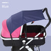 A purple and pink canopy sun shade is shown attached to a baby stroller.