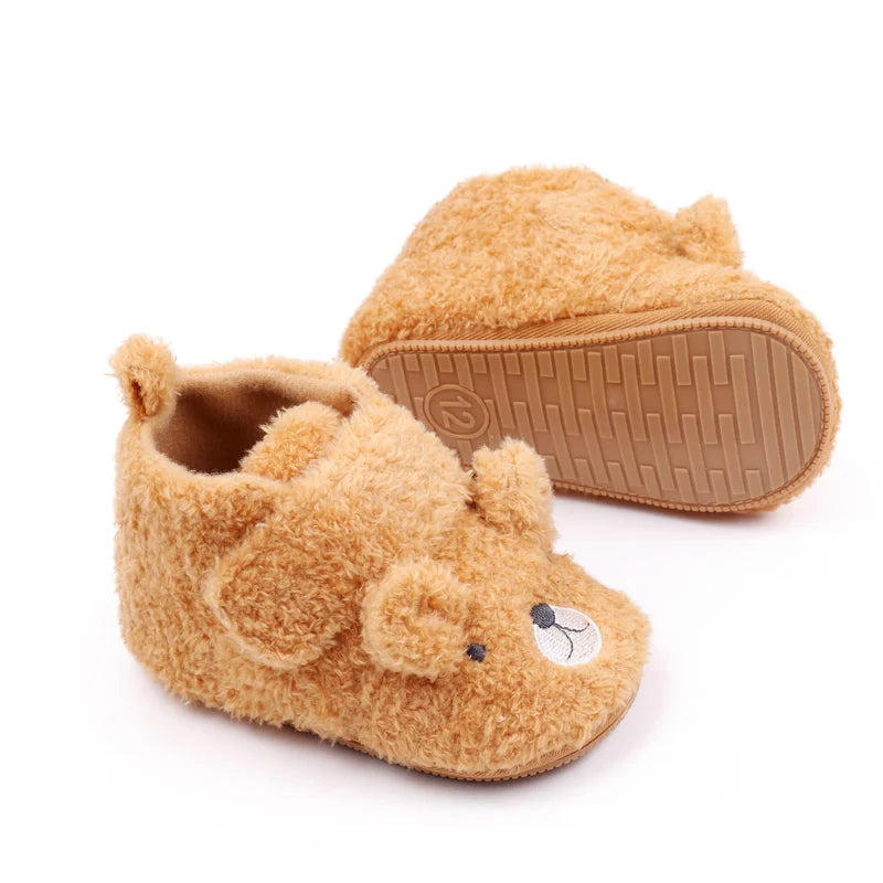A pair of cute bear design baby prewalker shoes with a soft anti-slip sole.