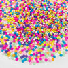 A pile of colorful polymer clay star and heart sprinkles in various bright colors like pink, yellow, blue, and purple.