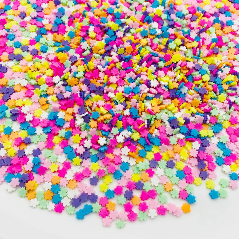 A pile of colorful polymer clay star and heart sprinkles in various bright colors like pink, yellow, blue, and purple.
