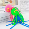 A bright green squeeze water octopus bath toy with pink tentacles is shown against a white background.