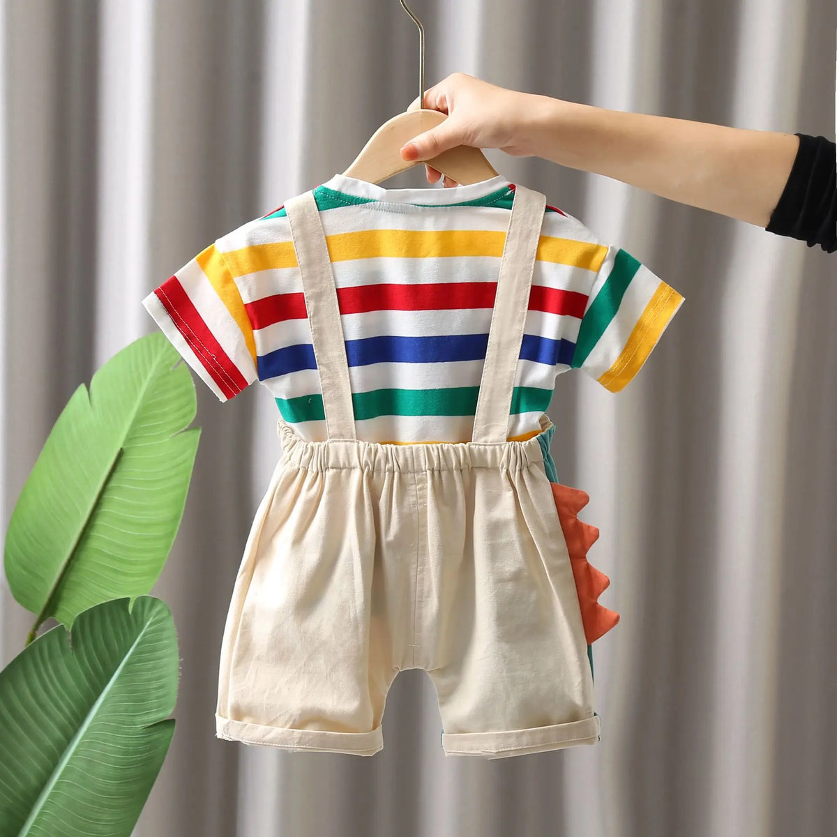 A child's two-piece outfit set featuring a striped shirt and matching shorts, displayed on a hanger.