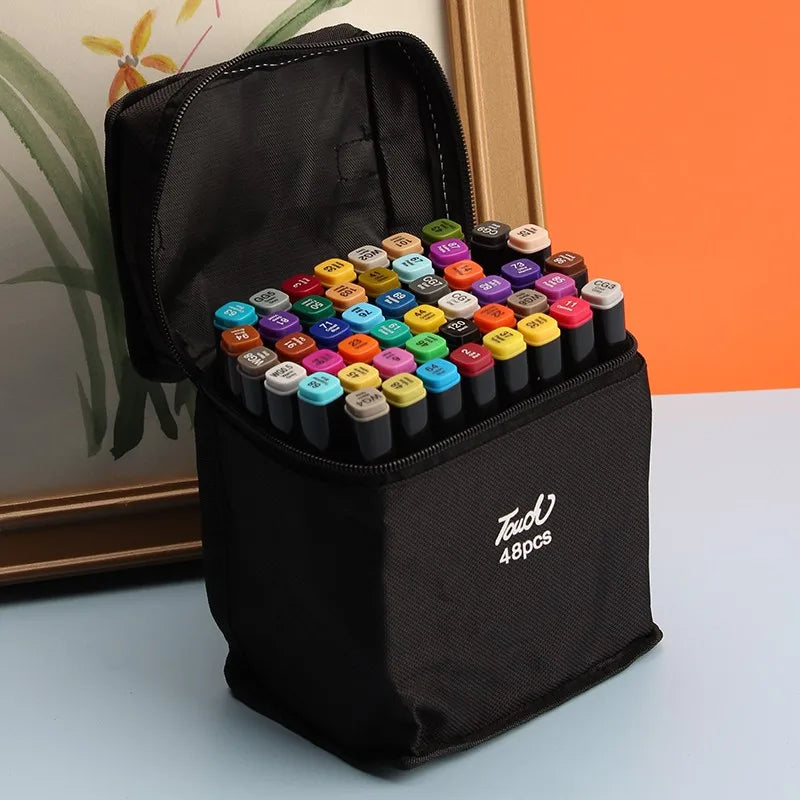 A black zippered pouch containing a set of alcohol art markers with various colored tips.