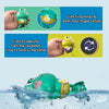 A green frog wind-up bath toy is shown swimming in water.