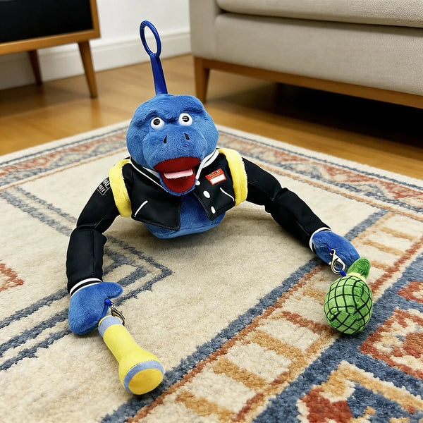 A blue animal plush toy with a yellow leash and green ball lying on a rug.