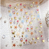 Clear sheet of 3D ocean-themed nail art stickers featuring gold shells and starfish