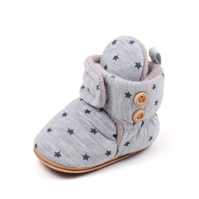 Gray baby winter snow boots with fuzzy ball accents and star patterns