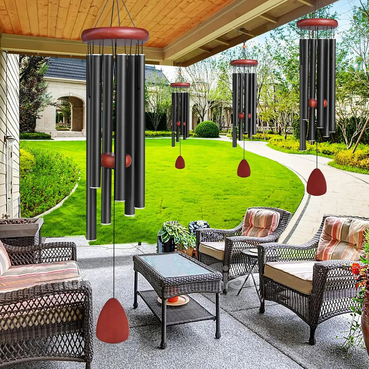 A set of hanging wind chimes with terracotta-colored accents suspended from a wooden pergola in a garden setting.