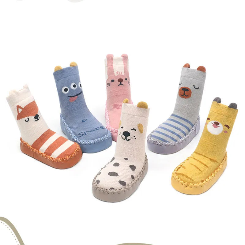 A collection of cute cartoon animal non-slip socks in various colors and patterns for babies and toddlers.