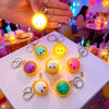 A collection of adorable dumpling stress relief keychains with LED lights in various colors and shapes.