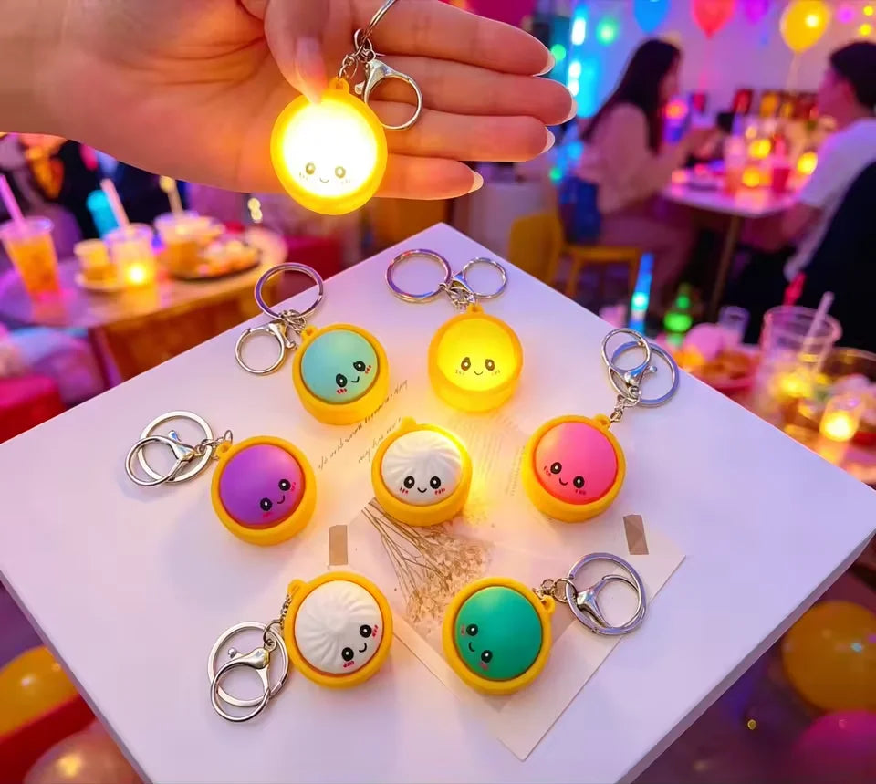 A collection of adorable dumpling stress relief keychains with LED lights in various colors and shapes.