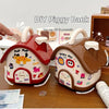 A DIY house-shaped piggy bank in red and white, featuring a lock and key mechanism for saving money.