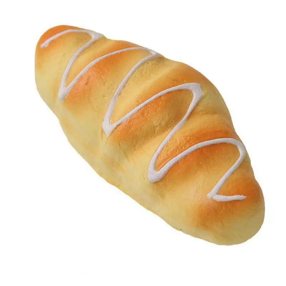 A golden loaf of bread with white decorative stripes, used as a realistic squeeze toy.
