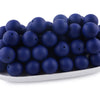 A pile of dark blue silicone round beads for jewelry making and crafting.