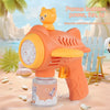 An orange bear-shaped automatic bubble gun with a light feature is shown on a sandy beach.