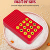 A red button with yellow sound effect buttons is placed on a pink plate surrounded by white salt crystals.
